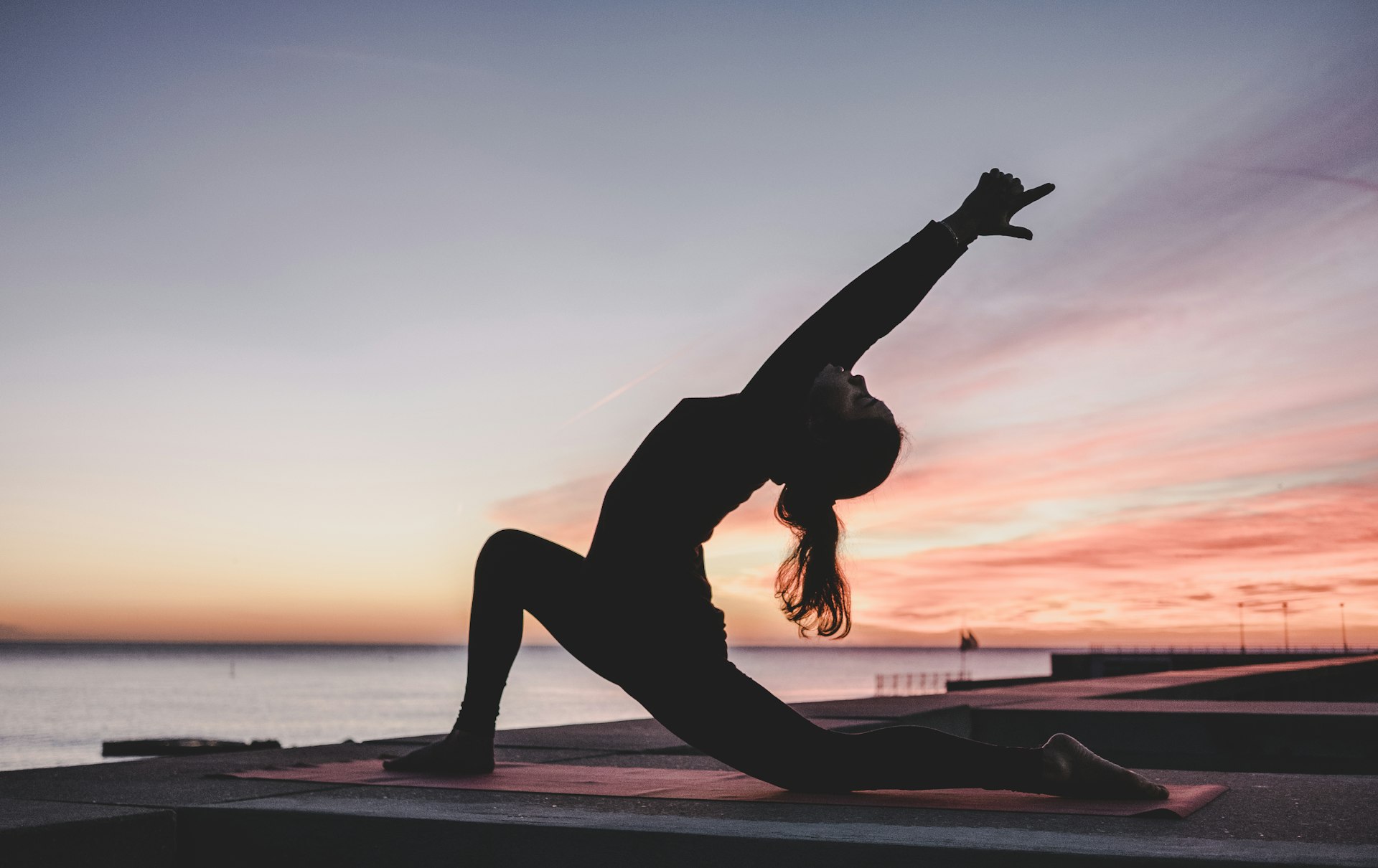 Person practicing mindful wellness in a calm, natural setting