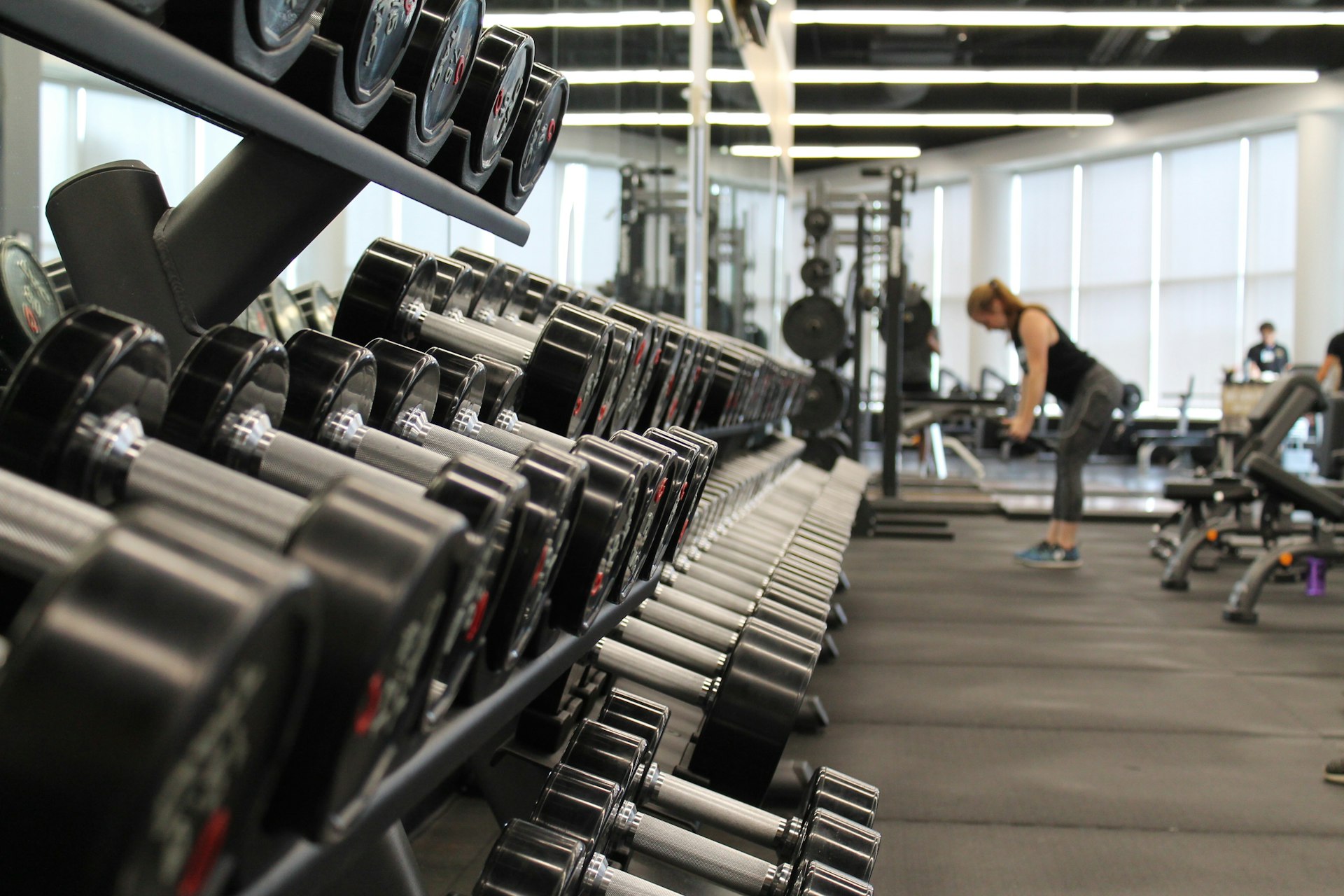 Man lifting weights in a gym representing strength and vitality